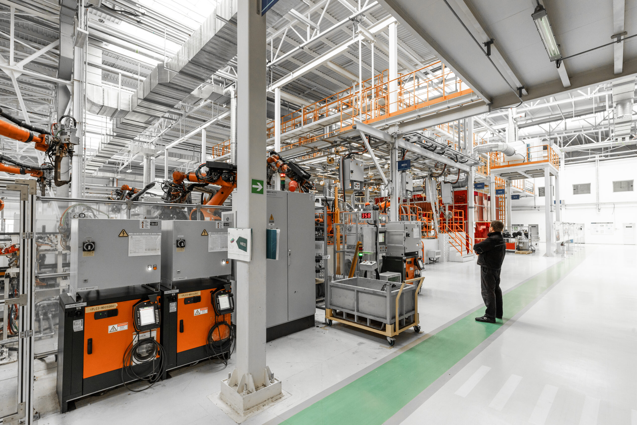 Photo of automobile production line. Welding car body. Modern car assembly plant. Auto industry. Interior of a high-tech factory, modern production